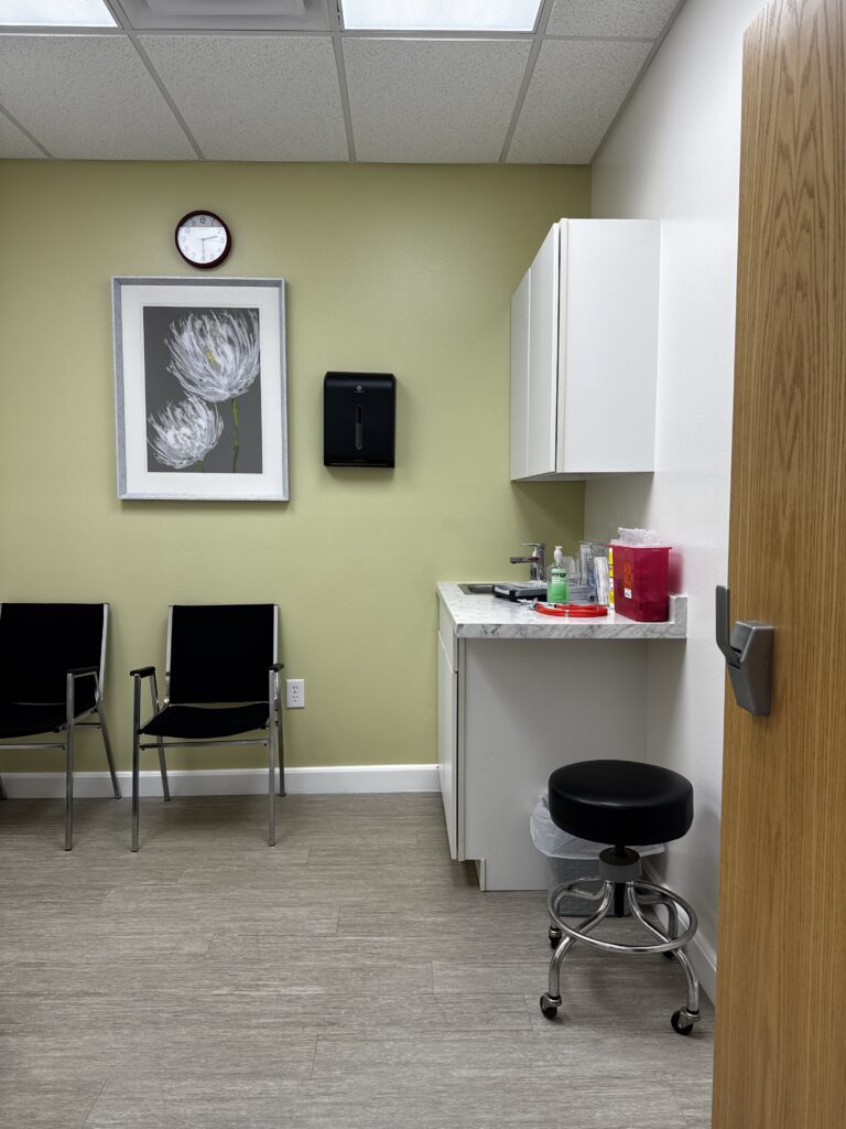 Exam room with blood pressure monitor at LLB Medical Clinic at Peppertree in Ocala, Florida